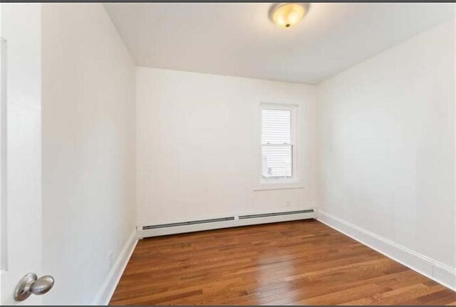 57 School St, East Providence, RI 02914 - unfurnished room featuring a baseboard radiator, wood finished floors, and baseboards