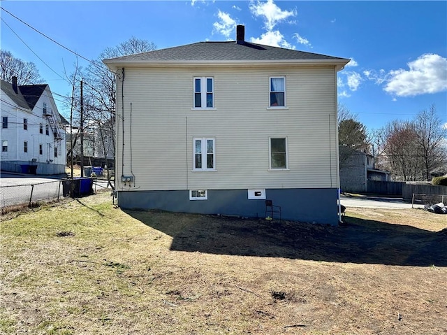 view of home's exterior with fence