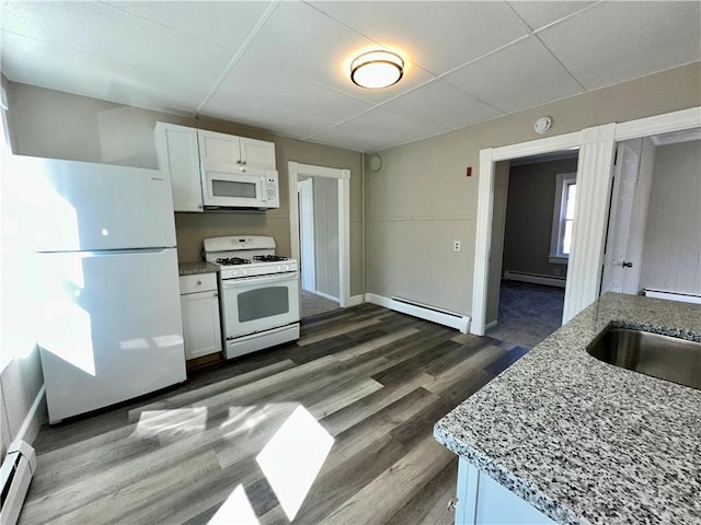 kitchen featuring a sink, baseboard heating, white appliances, a baseboard heating unit, and dark wood-type flooring