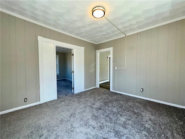 carpeted empty room featuring a baseboard radiator, crown molding, and baseboards