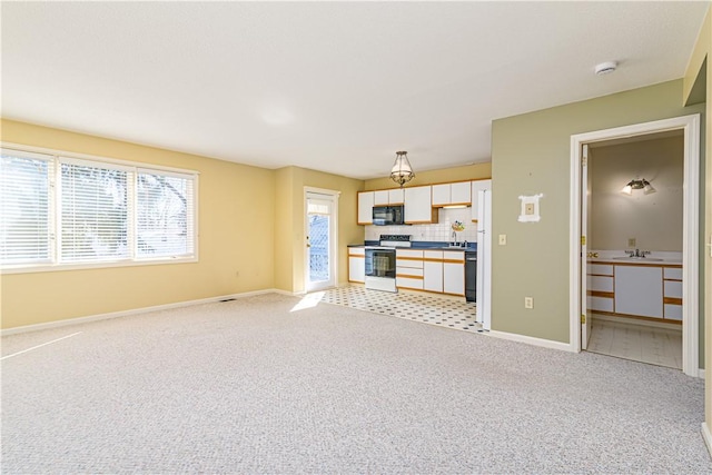 60 Margin St Unit 104, Westerly, RI 02891 - unfurnished living room with light carpet