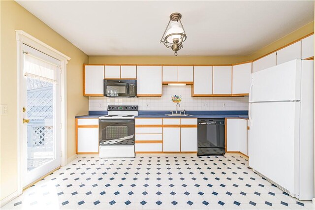 60 Margin St Unit 104, Westerly, RI 02891 - kitchen with black appliances, white cabinets, decorative backsplash, and dark countertops