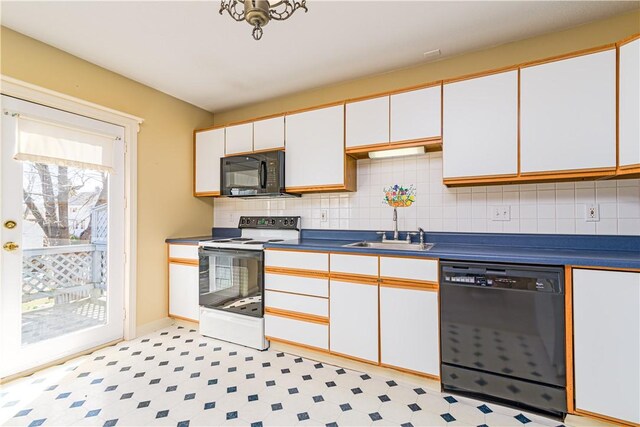 60 Margin St Unit 104, Westerly, RI 02891 - kitchen with black appliances, white cabinets, decorative backsplash, light floors, and dark countertops
