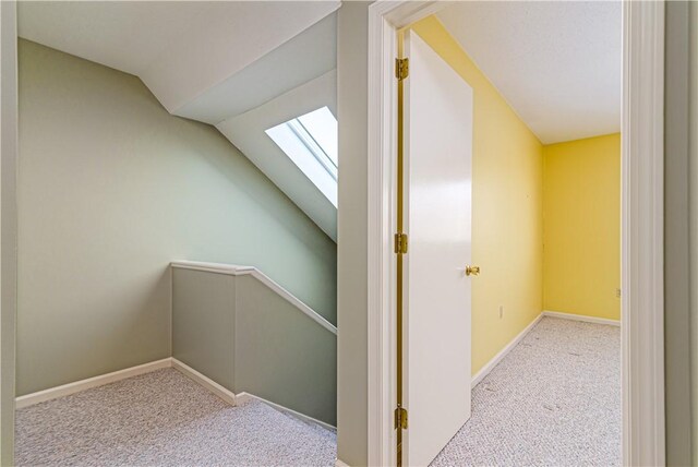 60 Margin St Unit 104, Westerly, RI 02891 - corridor featuring a skylight, carpet, lofted ceiling, and an upstairs landing