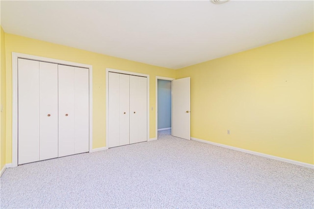 60 Margin St Unit 104, Westerly, RI 02891 - unfurnished bedroom with multiple closets and light colored carpet