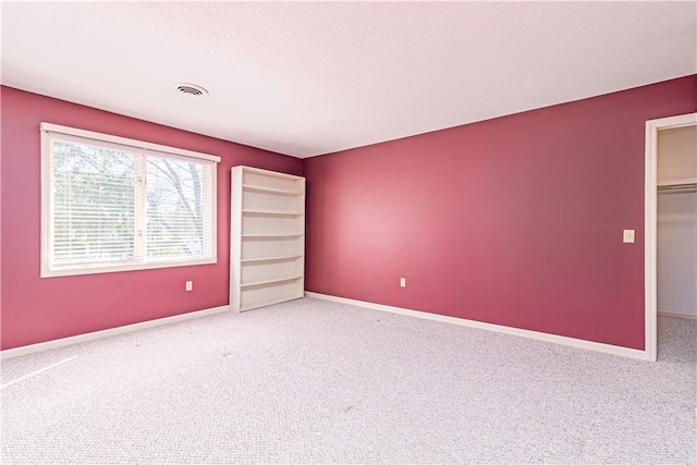 60 Margin St Unit 104, Westerly, RI 02891 - unfurnished bedroom with carpet, a walk in closet, and a closet