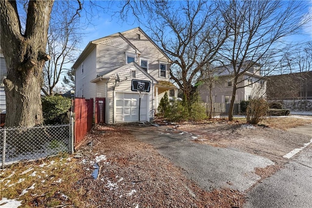 view of front of home featuring a garage and fence