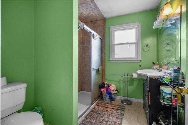 bathroom with a shower stall, tile patterned floors, toilet, and vanity