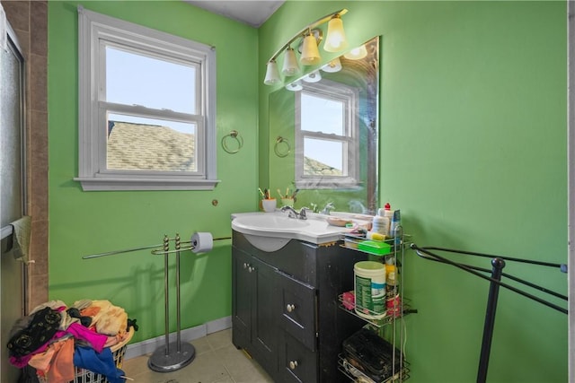 bathroom with baseboards, vanity, and tile patterned floors