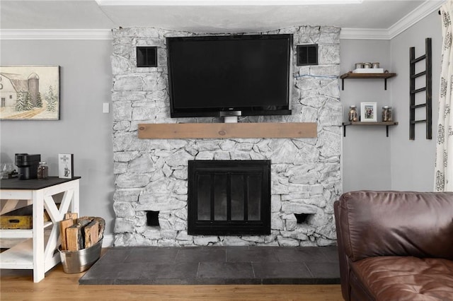 living room featuring visible vents, a fireplace, crown molding, and wood finished floors