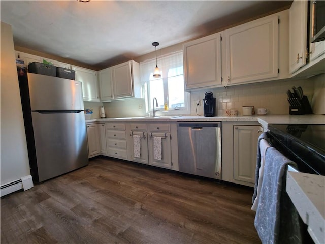 kitchen with a sink, white cabinetry, appliances with stainless steel finishes, and dark wood-type flooring