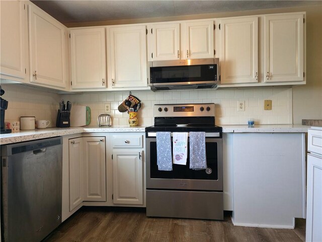 kitchen with white cabinetry, stainless steel appliances, dark wood-type flooring, and tasteful backsplash
