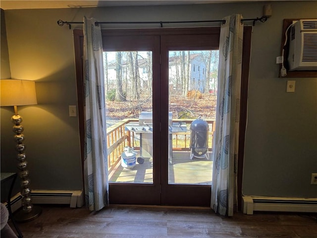 doorway to outside featuring baseboard heating, wood finished floors, an AC wall unit, and french doors