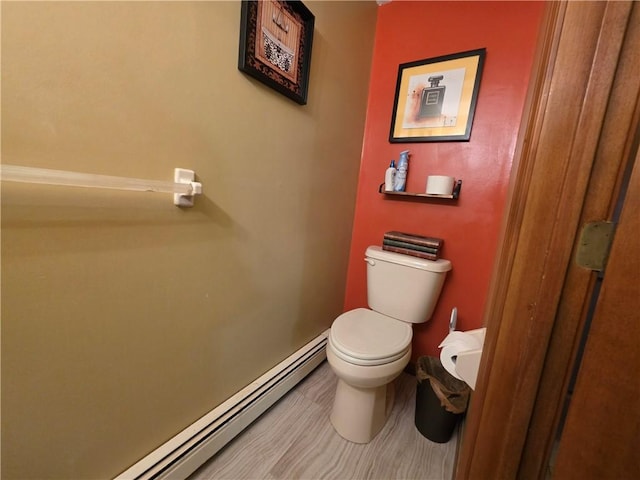 half bath featuring toilet and a baseboard radiator