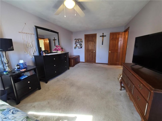 bedroom featuring light carpet and a ceiling fan