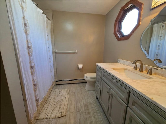 bathroom with a baseboard radiator, toilet, vanity, and a shower with shower curtain