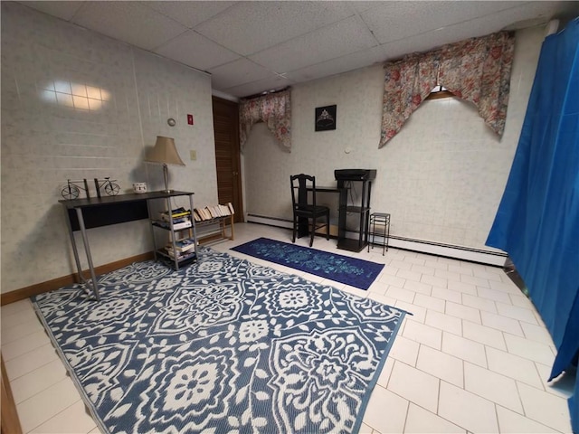sitting room with a paneled ceiling and baseboard heating