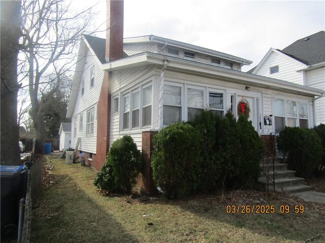 view of front facade with a chimney