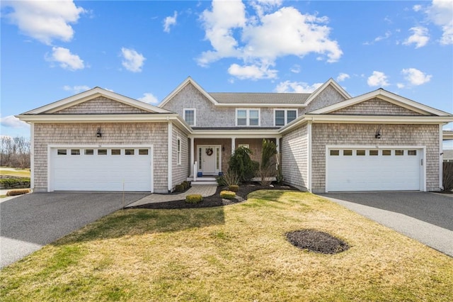 shingle-style home featuring aphalt driveway, a garage, and a front yard
