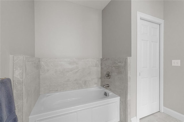 bathroom featuring baseboards and a garden tub