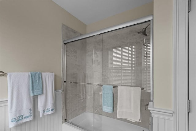 full bath with a wainscoted wall