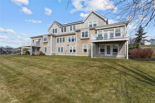 rear view of property with a lawn and a deck