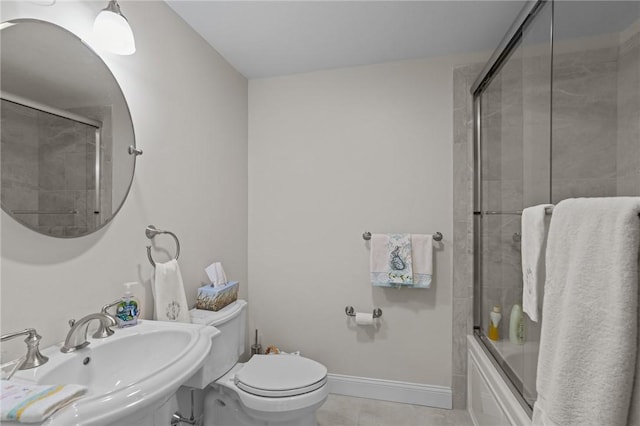 full bath with tile patterned flooring, toilet, baseboards, a sink, and enclosed tub / shower combo