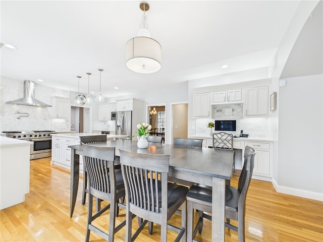 dining room featuring recessed lighting, light wood-style flooring, and baseboards