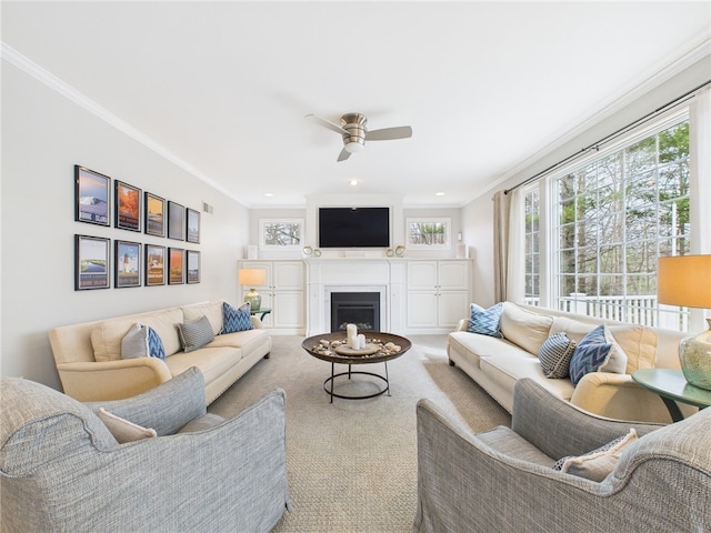 carpeted living area featuring recessed lighting, a fireplace, ceiling fan, visible vents, and ornamental molding