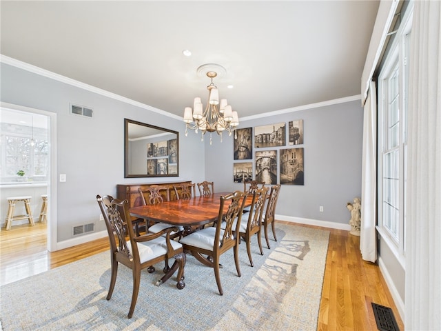 dining space featuring visible vents and crown molding