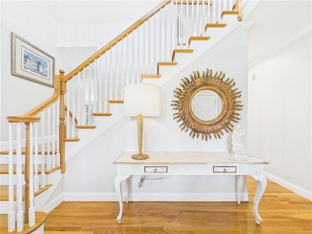 stairs with wood finished floors and baseboards