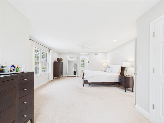 bedroom with baseboards, visible vents, light colored carpet, and recessed lighting