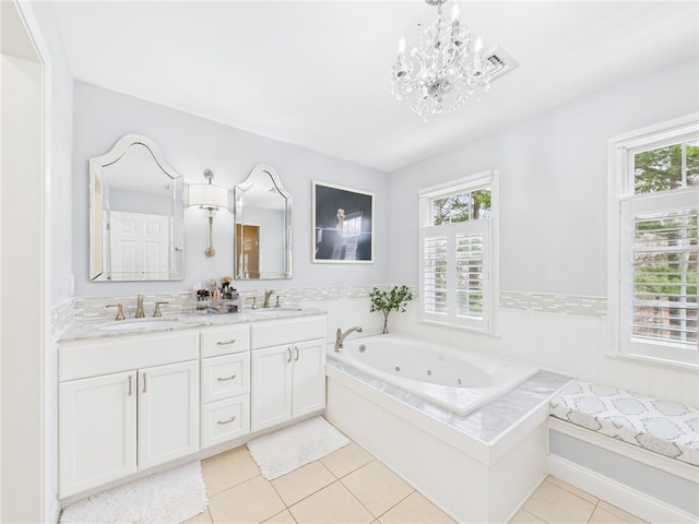 bathroom featuring double vanity, a sink, a chandelier, and a healthy amount of sunlight