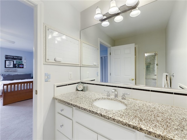 bathroom with an inviting chandelier and vanity