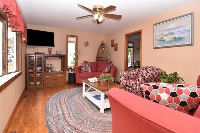 living room featuring ceiling fan and light wood finished floors