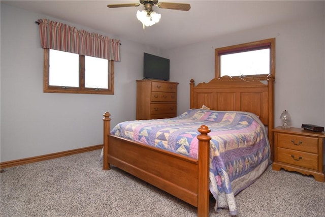 carpeted bedroom with baseboards and a ceiling fan