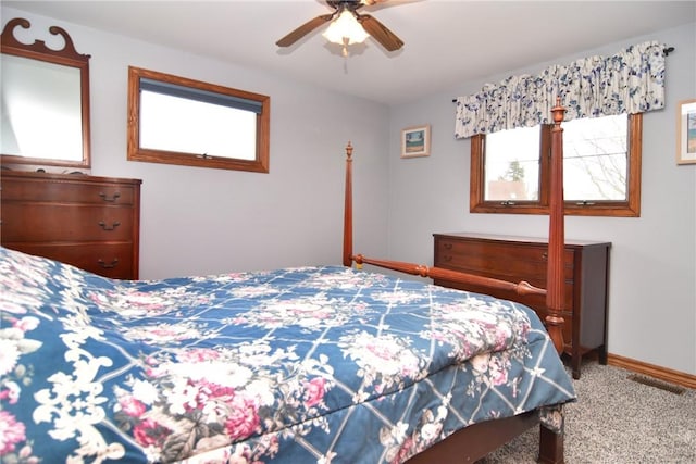 bedroom featuring baseboards, carpet flooring, visible vents, and a ceiling fan