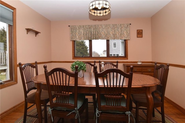 dining space featuring baseboards and wood finished floors