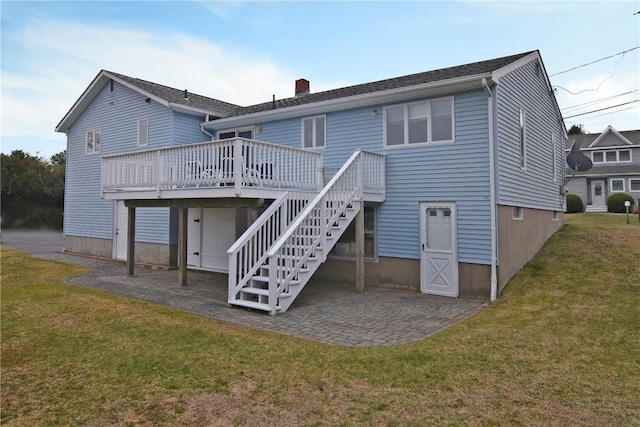 rear view of property featuring stairs, a chimney, a wooden deck, a patio, and a yard