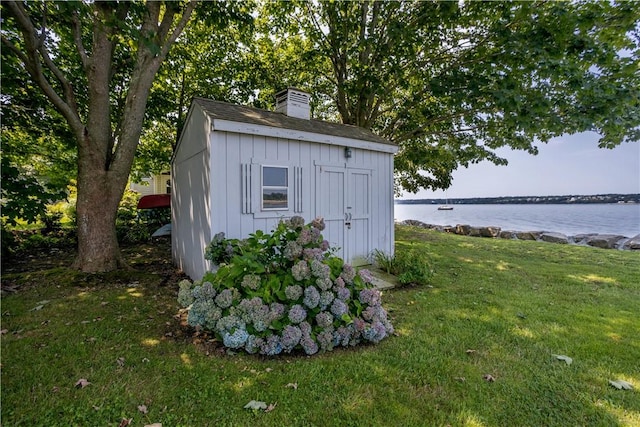 view of shed with a water view