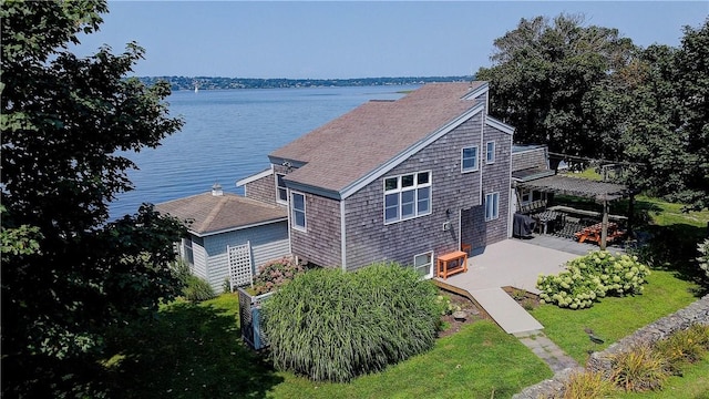 birds eye view of property with a water view
