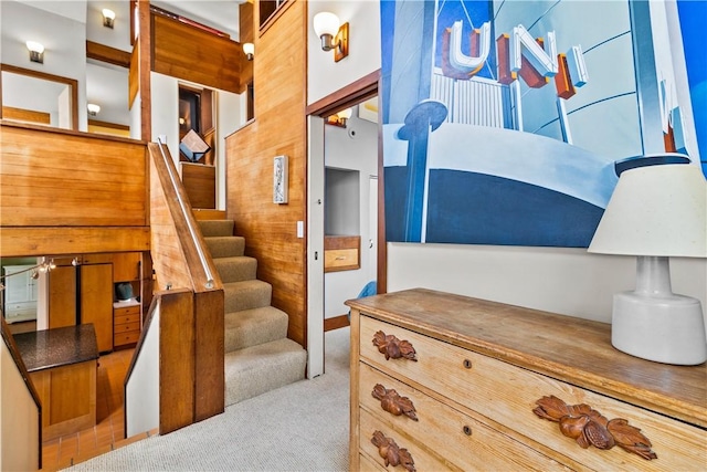 interior space featuring carpet flooring and stairs