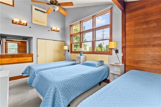 bedroom with carpet, a closet, high vaulted ceiling, and multiple windows