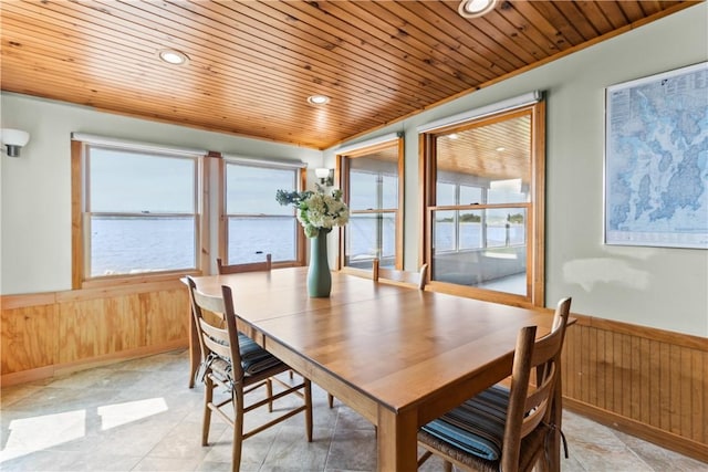 dining space featuring wooden ceiling, a wainscoted wall, wooden walls, and recessed lighting