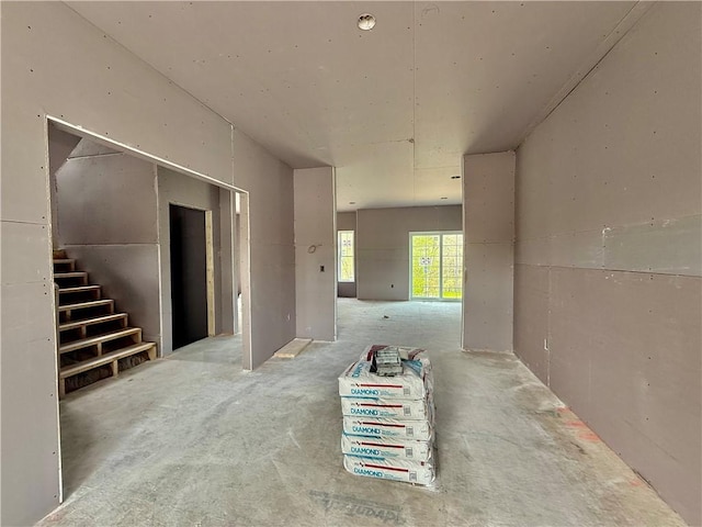 empty room with carpet and stairway