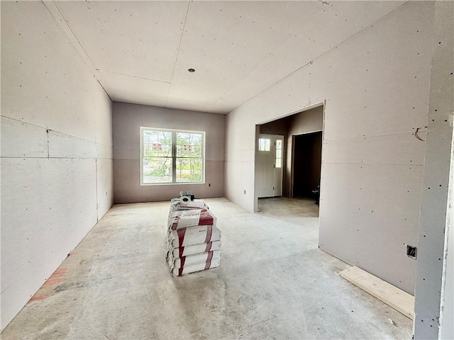 spare room featuring unfinished concrete flooring