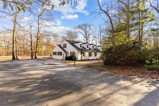 view of side of property featuring aphalt driveway