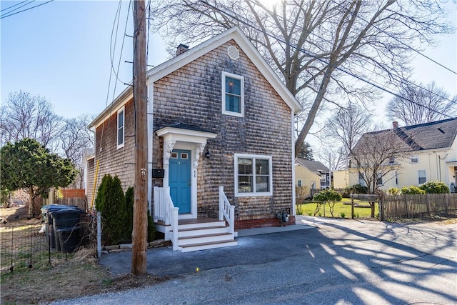 view of front of property with fence and a chimney