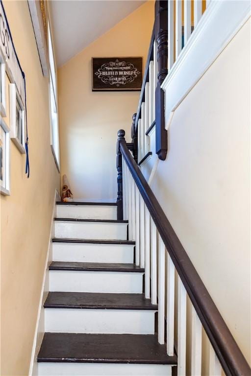 stairs featuring lofted ceiling