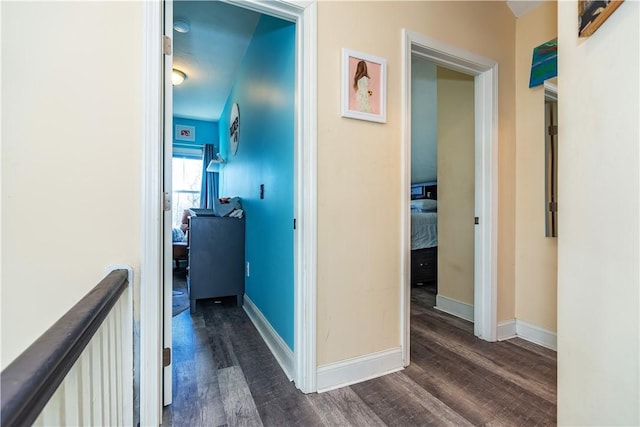 hall with dark wood-style floors and baseboards